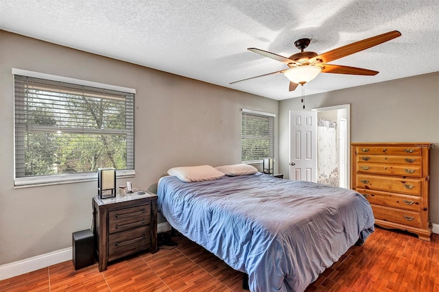 6906 Colony Oaks Ln, Orlando, FL 32818 - bedroom with baseboards, wood finished floors, a textured ceiling, and ceiling fan
