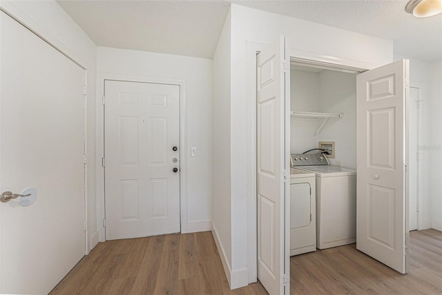 11901 4th St N Unit 2107, Saint Petersburg, FL 33716 - laundry room with washing machine and dryer and light wood finished floors
