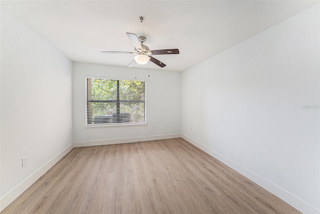 11901 4th St N Unit 2107, Saint Petersburg, FL 33716 - empty room featuring light wood-type flooring, a ceiling fan, and baseboards