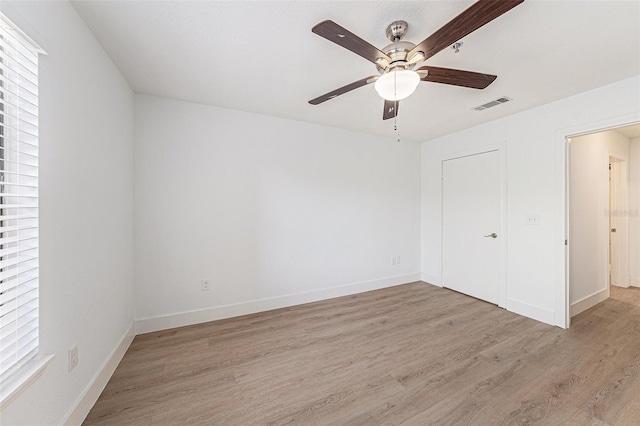 11901 4th St N Unit 2107, Saint Petersburg, FL 33716 - unfurnished bedroom featuring light wood-style flooring, baseboards, and a ceiling fan
