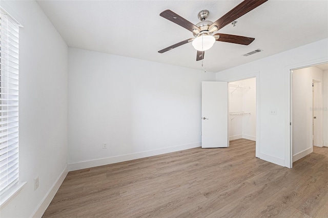 11901 4th St N Unit 2107, Saint Petersburg, FL 33716 - unfurnished bedroom with light wood finished floors, baseboards, a spacious closet, and a closet