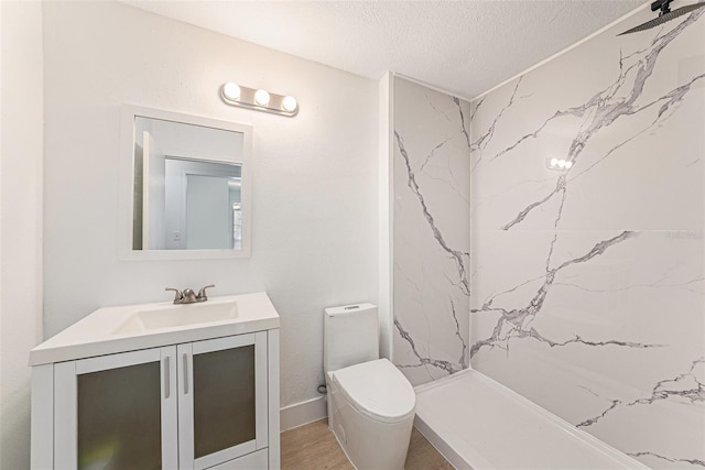 11901 4th St N Unit 2107, Saint Petersburg, FL 33716 - bathroom featuring a textured ceiling, vanity, toilet, a shower, and wood finished floors