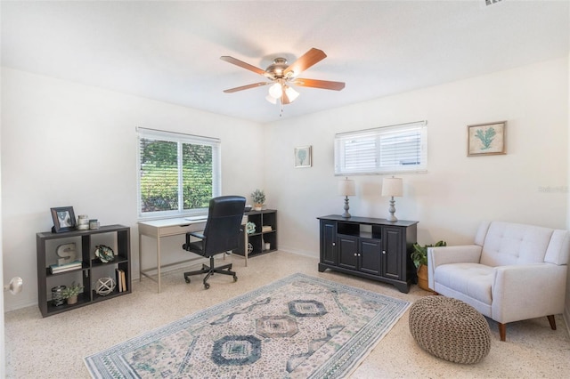 home office featuring ceiling fan, speckled floor, and baseboards