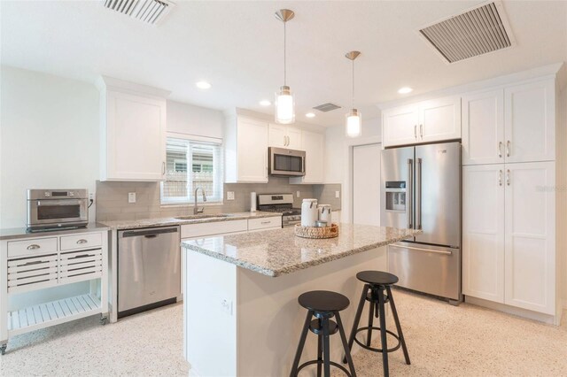 kitchen featuring white cabinetry, a sink, appliances with stainless steel finishes, and visible vents