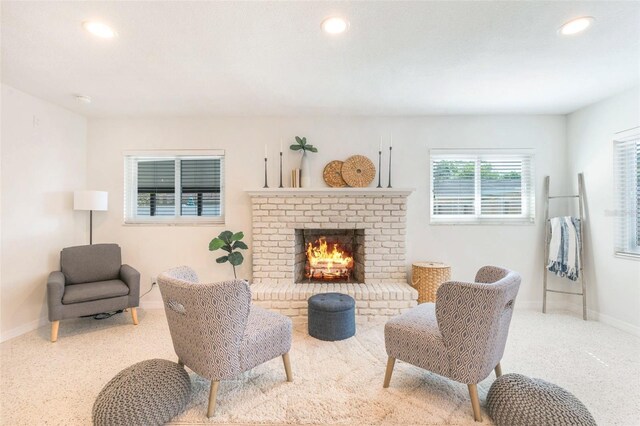 living area with a fireplace, recessed lighting, and baseboards