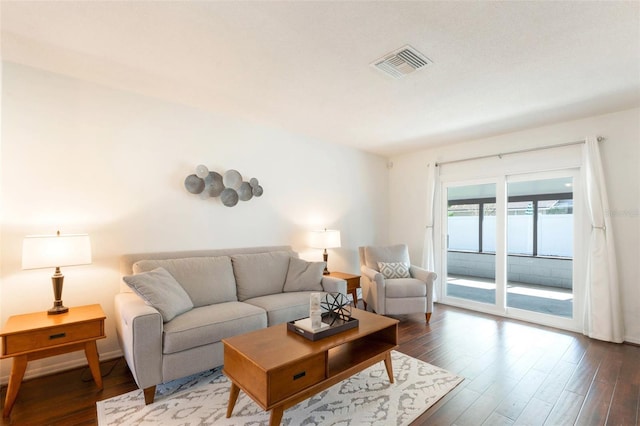 living room with visible vents and dark wood-style floors