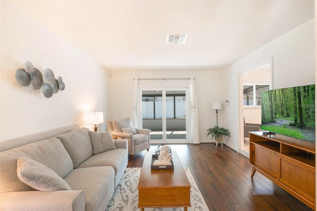 living room with dark wood-type flooring and visible vents