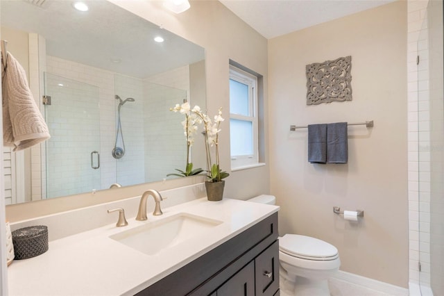 bathroom with recessed lighting, a shower stall, vanity, toilet, and baseboards