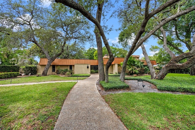single story home featuring a front lawn and stucco siding