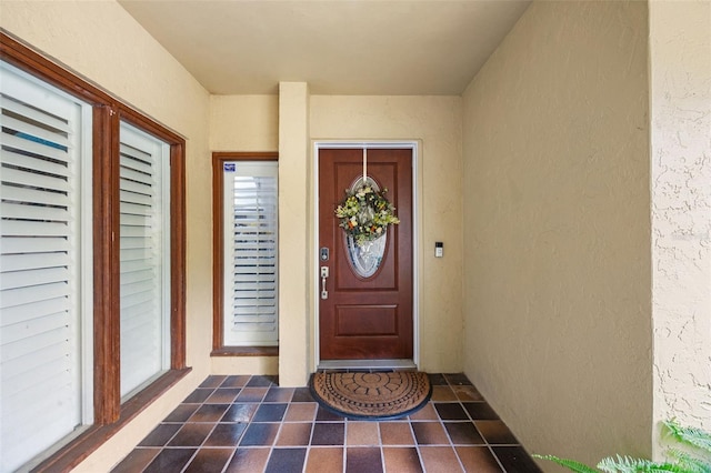 property entrance featuring stucco siding