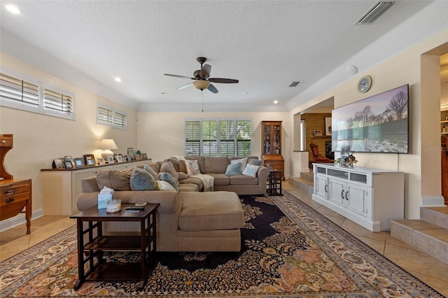 living area with a textured ceiling, visible vents, recessed lighting, a ceiling fan, and light tile patterned floors