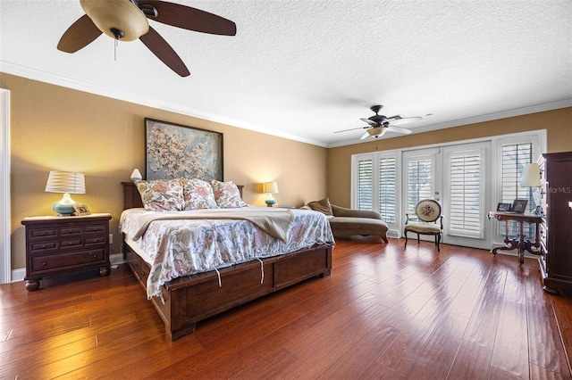 bedroom featuring access to exterior, ornamental molding, dark wood-style flooring, a textured ceiling, and ceiling fan