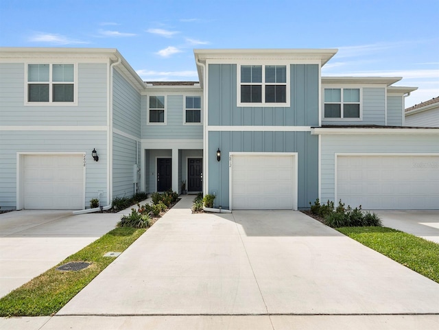 2812 Bright Bird Ln, Winter Park, FL 32792 - townhome / multi-family property with board and batten siding, an attached garage, and concrete driveway