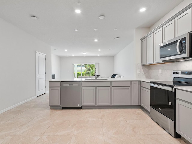2812 Bright Bird Ln, Winter Park, FL 32792 - kitchen with recessed lighting, a peninsula, stainless steel appliances, and gray cabinetry