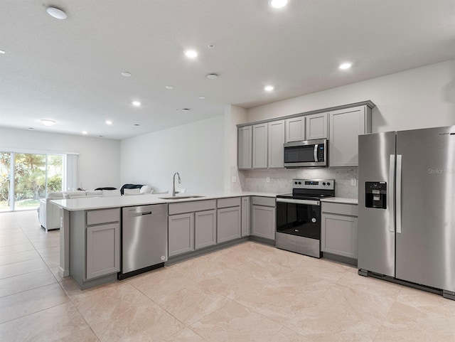 2812 Bright Bird Ln, Winter Park, FL 32792 - kitchen featuring stainless steel appliances, a peninsula, gray cabinetry, and a sink