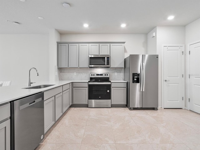 2812 Bright Bird Ln, Winter Park, FL 32792 - kitchen with tasteful backsplash, gray cabinetry, stainless steel appliances, and a sink
