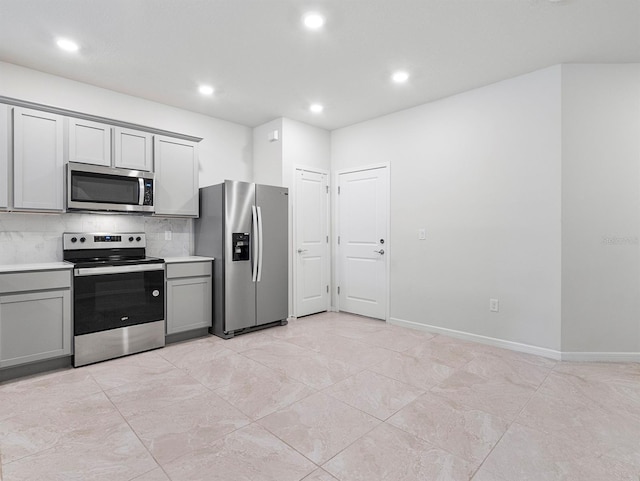 2812 Bright Bird Ln, Winter Park, FL 32792 - kitchen with gray cabinets, stainless steel appliances, light countertops, backsplash, and recessed lighting
