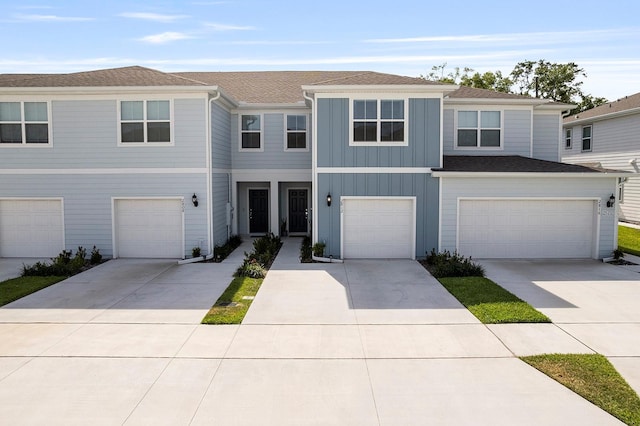 2812 Bright Bird Ln, Winter Park, FL 32792 - townhome / multi-family property with board and batten siding, an attached garage, a shingled roof, and driveway