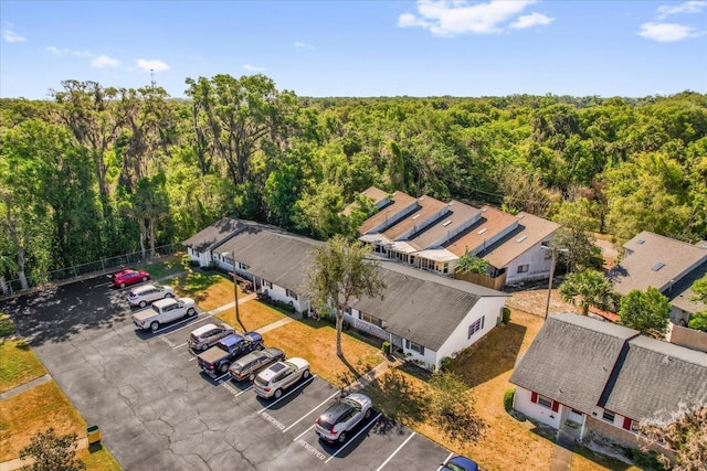 birds eye view of property with a forest view