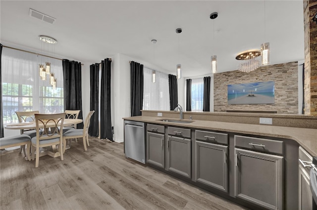 1114 Landale Ct, Orlando, FL 32828 - kitchen featuring dishwasher, gray cabinets, a chandelier, light wood-style flooring, and hanging light fixtures