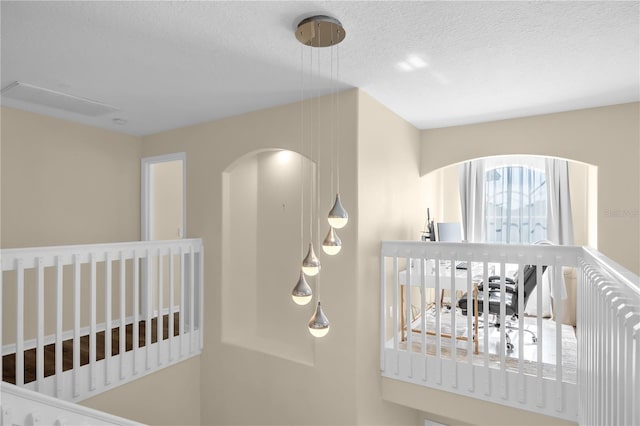 1114 Landale Ct, Orlando, FL 32828 - stairs with a textured ceiling and arched walkways