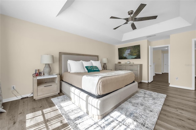 1114 Landale Ct, Orlando, FL 32828 - bedroom featuring a raised ceiling, wood finished floors, and ceiling fan
