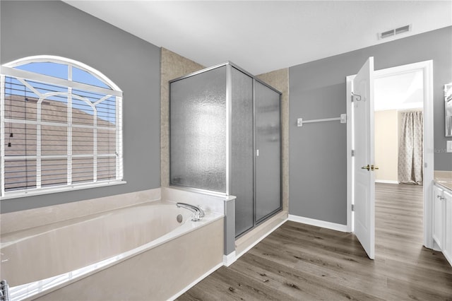 1114 Landale Ct, Orlando, FL 32828 - full bath with vanity, wood finished floors, a garden tub, and a shower stall