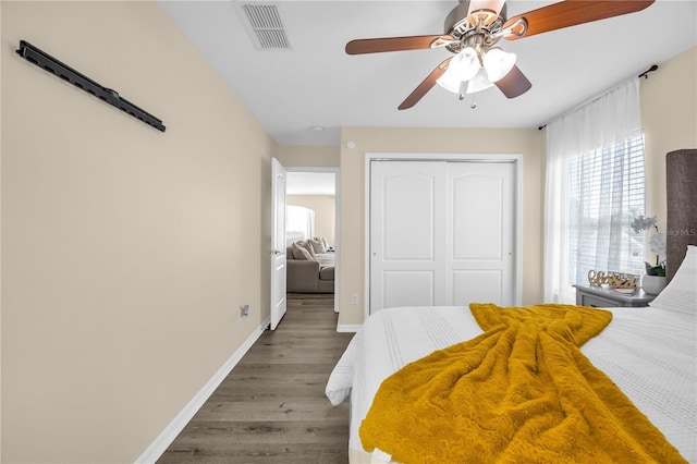 1114 Landale Ct, Orlando, FL 32828 - bedroom featuring multiple windows, wood finished floors, a closet, and a ceiling fan
