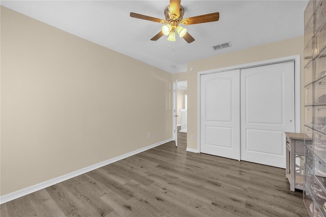 1114 Landale Ct, Orlando, FL 32828 - unfurnished bedroom with wood finished floors, a closet, and a ceiling fan
