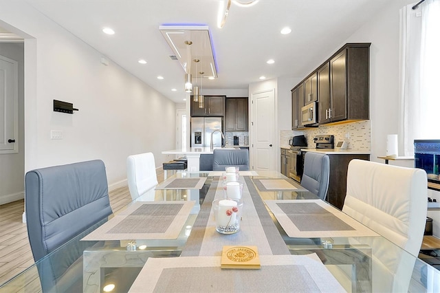 260 Lake Smart Cir, Winter Haven, FL 33881 - dining room featuring light wood-style flooring, baseboards, and recessed lighting