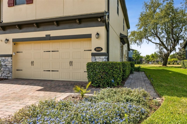 garage with decorative driveway