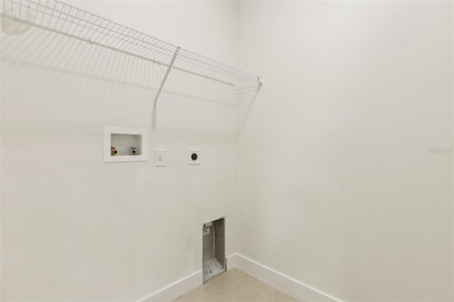 clothes washing area featuring baseboards, hookup for an electric dryer, hookup for a washing machine, and laundry area
