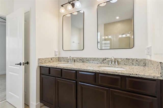 bathroom with a sink and double vanity