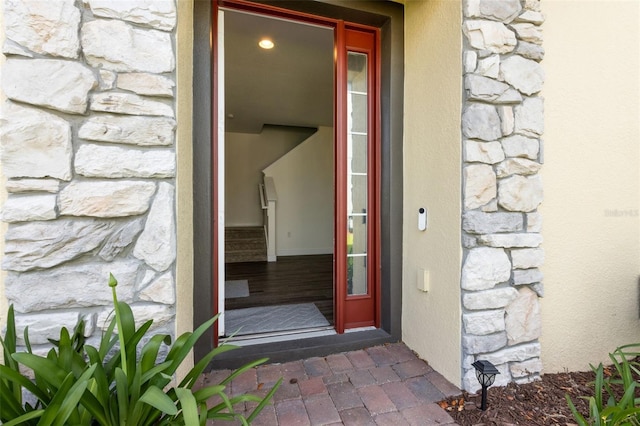 entrance to property featuring stone siding