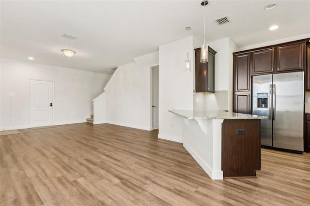 kitchen with light wood finished floors, baseboards, visible vents, dark brown cabinetry, and stainless steel fridge with ice dispenser