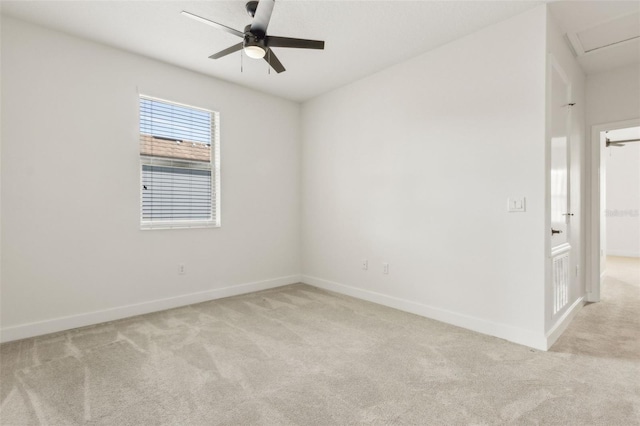 unfurnished room featuring light colored carpet, ceiling fan, and baseboards