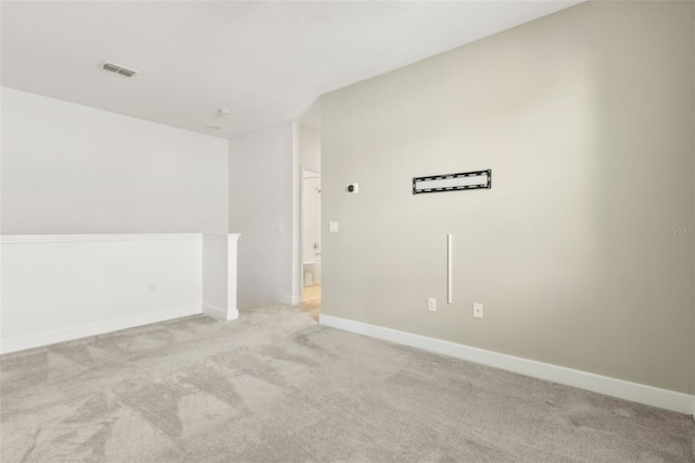 unfurnished room featuring light carpet, baseboards, and visible vents