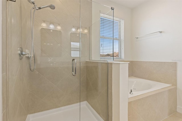 bathroom with a bath and a stall shower