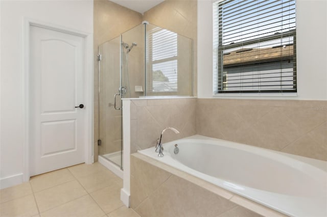 full bathroom featuring a garden tub, tile patterned flooring, a stall shower, and a wealth of natural light