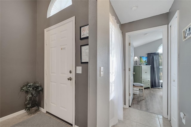 166 Laurel Ridge Pass, Davenport, FL 33897 - entrance foyer with light tile patterned floors, vaulted ceiling, and baseboards