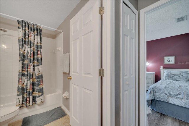 166 Laurel Ridge Pass, Davenport, FL 33897 - full bath featuring ensuite bath, a closet, shower / bath combo with shower curtain, toilet, and visible vents
