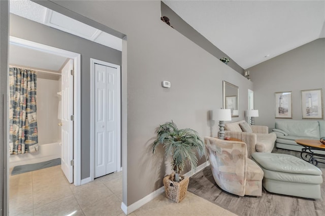 166 Laurel Ridge Pass, Davenport, FL 33897 - living room featuring lofted ceiling, light tile patterned floors, and baseboards