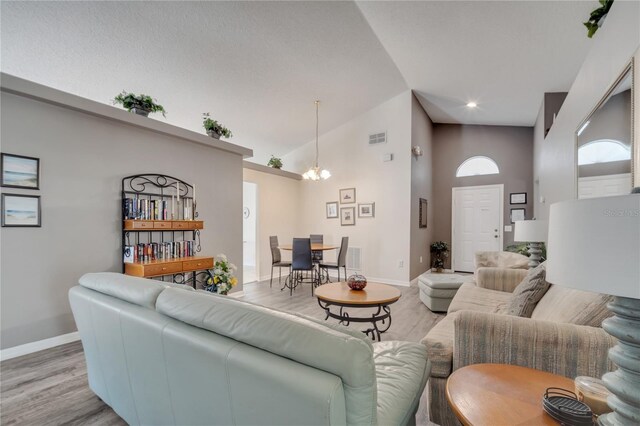 166 Laurel Ridge Pass, Davenport, FL 33897 - living room featuring baseboards, visible vents, light wood-style floors, and high vaulted ceiling