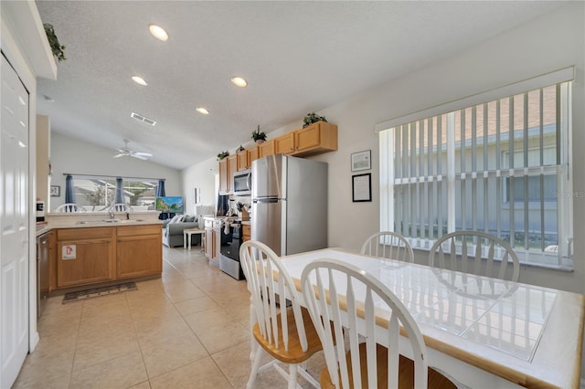 166 Laurel Ridge Pass, Davenport, FL 33897 - dining area with lofted ceiling, light tile patterned floors, visible vents, recessed lighting, and a ceiling fan