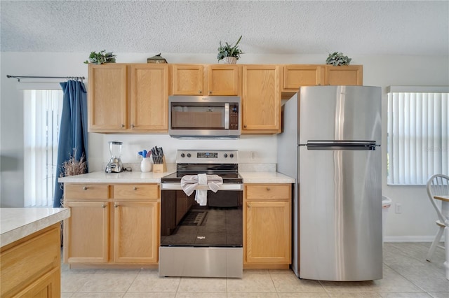 166 Laurel Ridge Pass, Davenport, FL 33897 - kitchen featuring light brown cabinets, stainless steel appliances, and light countertops