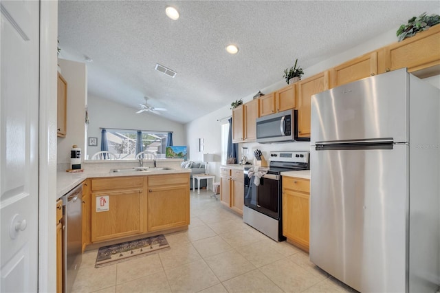 166 Laurel Ridge Pass, Davenport, FL 33897 - kitchen featuring a textured ceiling, a sink, visible vents, stainless steel appliances, and a peninsula