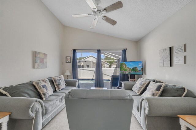 166 Laurel Ridge Pass, Davenport, FL 33897 - living room with light tile patterned floors, a ceiling fan, a textured ceiling, and lofted ceiling
