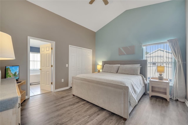 166 Laurel Ridge Pass, Davenport, FL 33897 - bedroom featuring baseboards, high vaulted ceiling, wood finished floors, and a closet