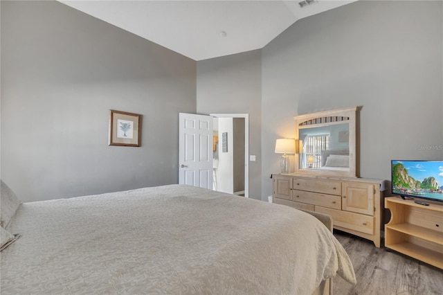 166 Laurel Ridge Pass, Davenport, FL 33897 - bedroom with high vaulted ceiling and wood finished floors
