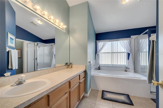166 Laurel Ridge Pass, Davenport, FL 33897 - bathroom featuring tile patterned floors, vaulted ceiling, vanity, a stall shower, and a garden tub